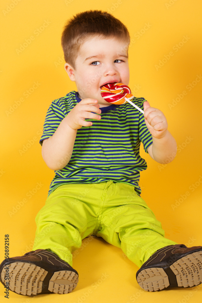 Little baby boy with motleyl candy Little baby boy with motleyl candy