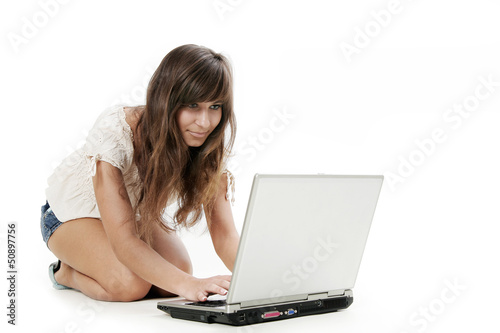 Young woman working with laptop on white background