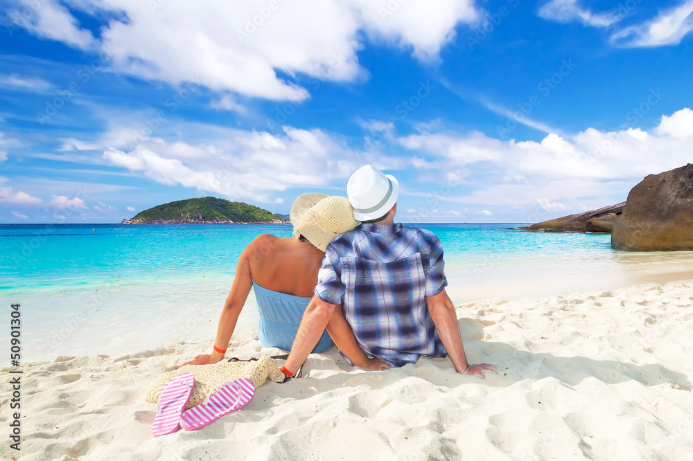 Couple in hug sitting together at the Caribbean Sea Couple in hug sitting together at the Caribbean Sea