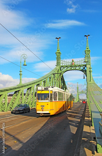 Orange tram on the Liberty bridge in Budapest, Hungary