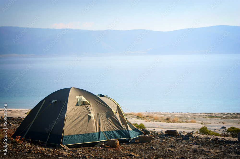 Camping tent in the nature by lake