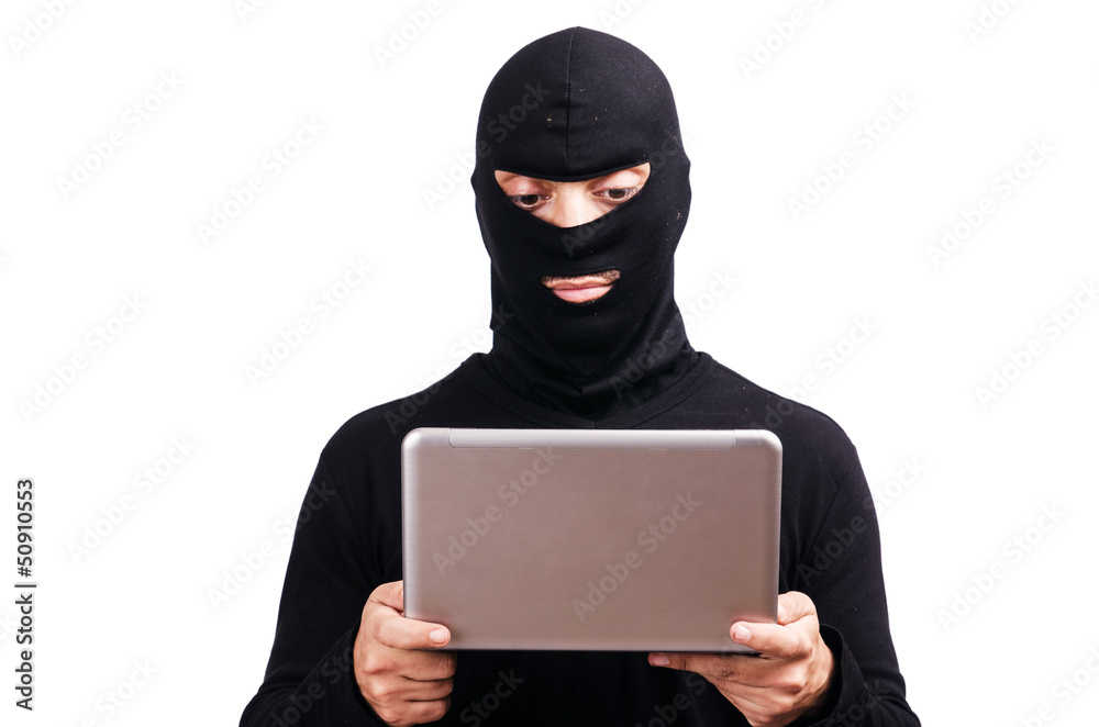 Hacker with computer wearing balaclava Hacker with computer wearing balaclava