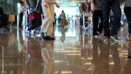 People with luggage walking in terminal airport