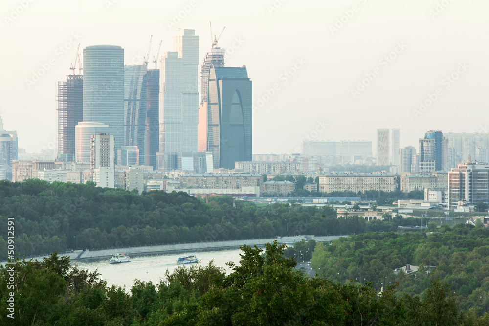 Cityscape of skyscrapers trees and river in Moscow