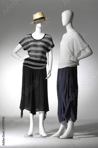 full-length female clothes on a two mannequin in light