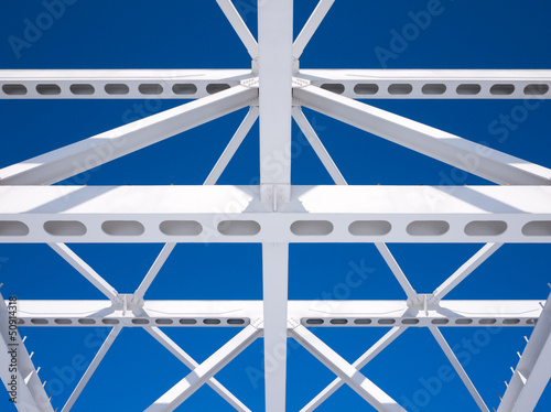 Steel beams against the blue sky. Fragment construction site. photo