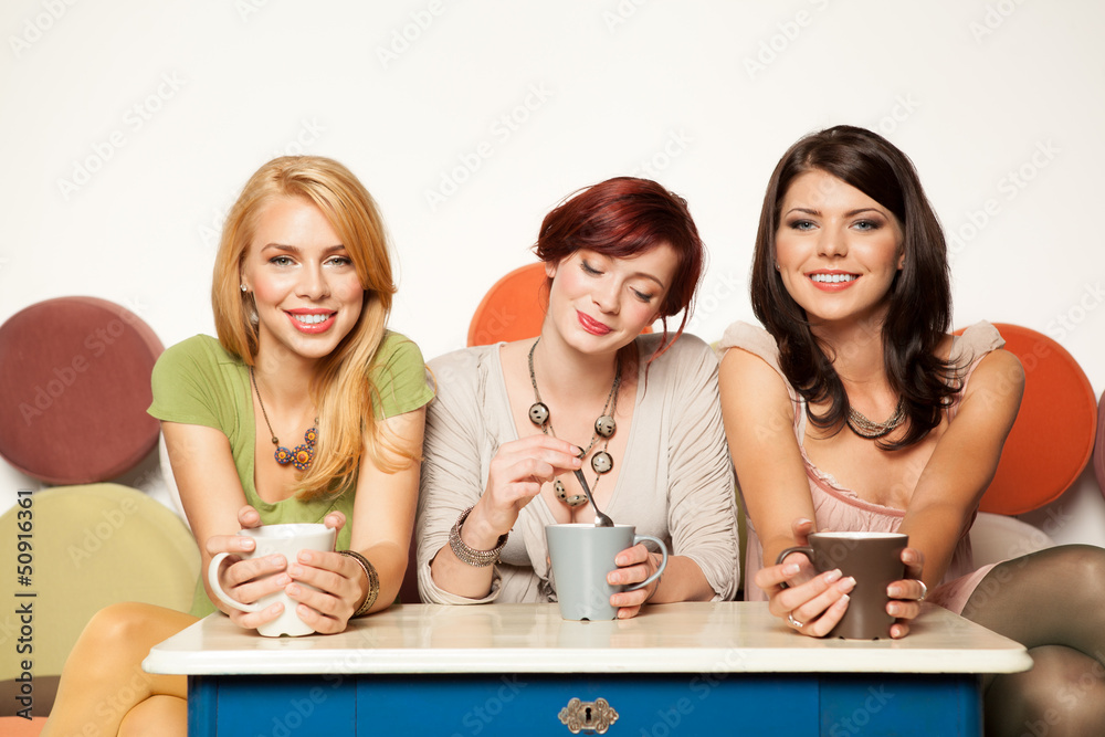 best friends enjoying themselves in a cafe best friends enjoying themselves in a cafe