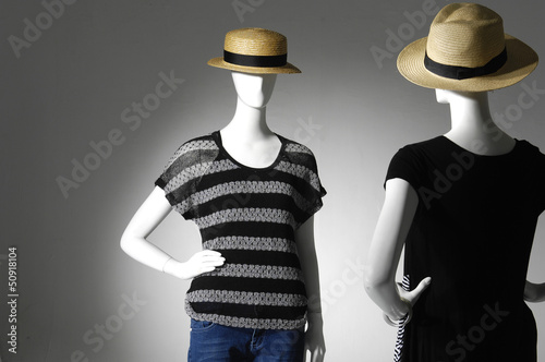 two female mannequin with hat in light background photo