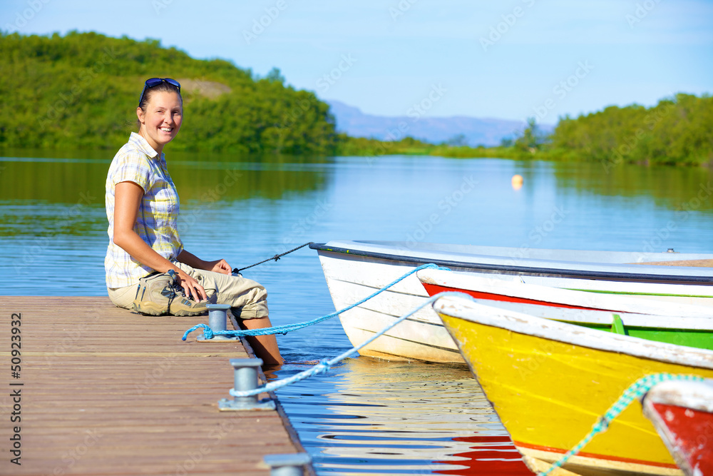 Woman sitting on a pier Woman sitting on a pier