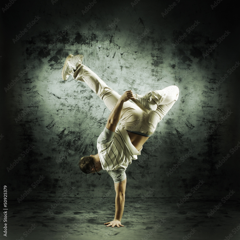 Sporty modern dancer over the dramatic background in sepia style