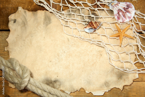 old paper, fishing net and rope on wooden table photo