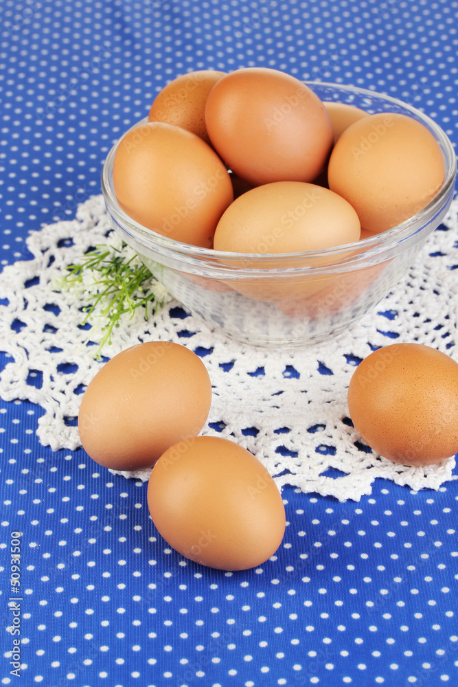 Eggs in bowl on blue tablecloth close-up Eggs in bowl on blue tablecloth close-up
