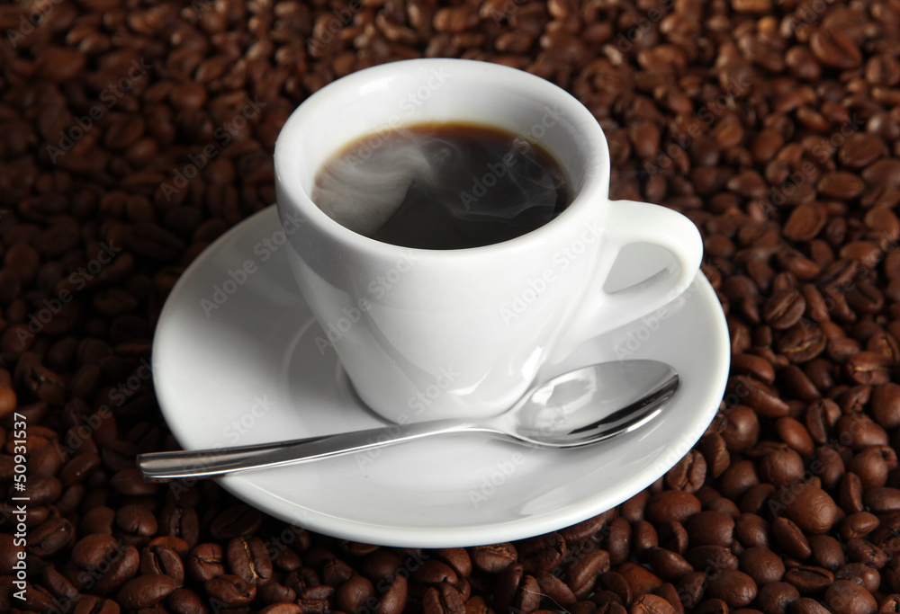 Cup of coffee on coffee beans background Cup of coffee on coffee beans background
