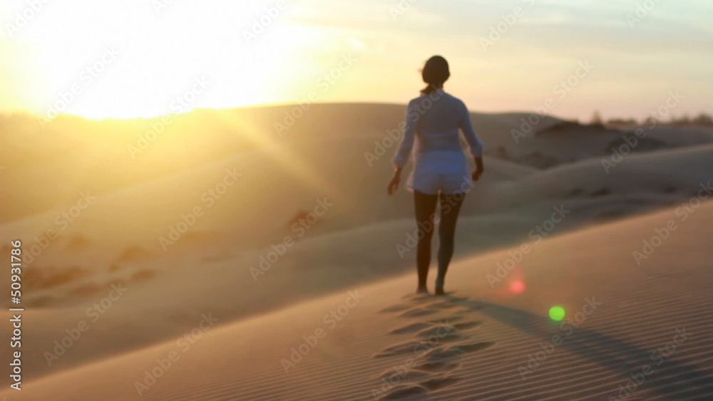 Sexy brunette girl in white dress posing on sand dune Sexy brunette girl in white dress posing on sand dune