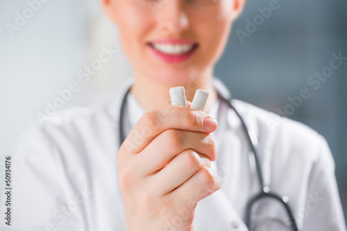 Female medical doctor - dentist - showing chewing gum. Dental ca photo