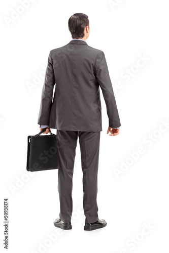 Full length portrait of a businessman with briefcase shot from b