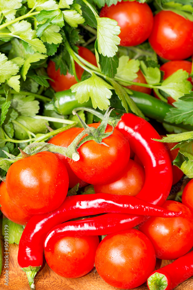 Tomato and red hot chili peppers on wooden table Tomato and red hot chili peppers on wooden table