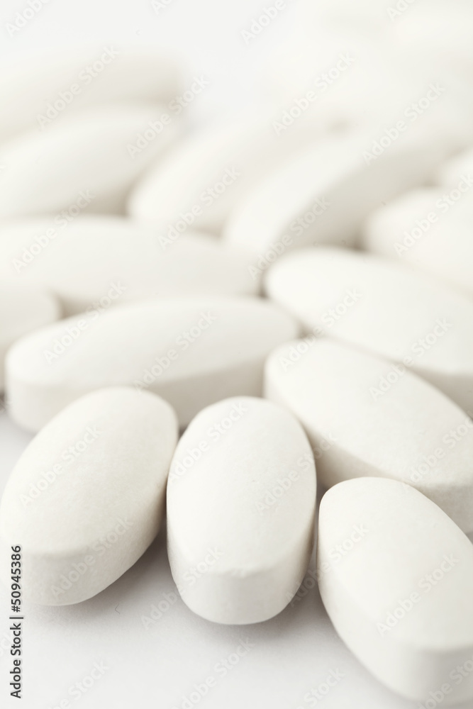 white medical tablets over white white medical tablets over white