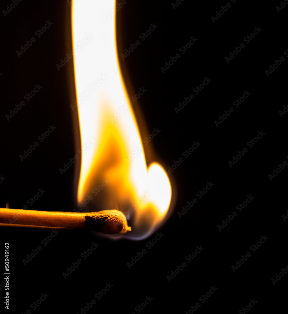 Burning match with a black background. Burning match with a black background.