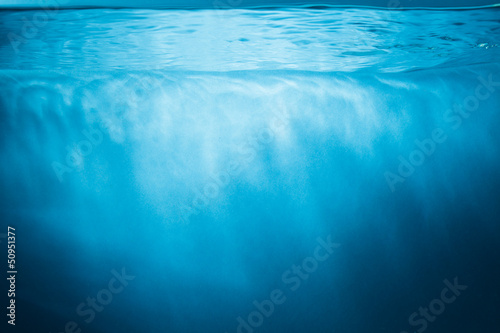 Abstract blue water background with sunbeams