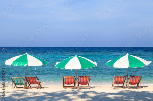 Colorful beach chairs and umbrellas on the beach