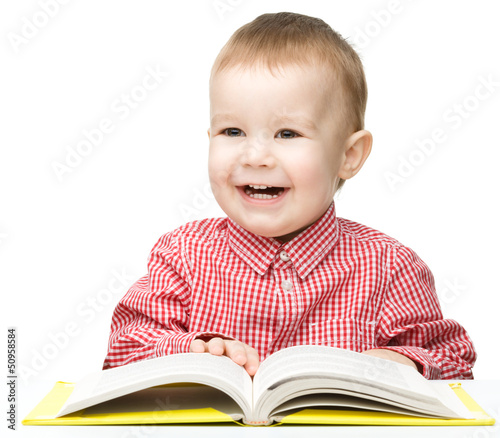 Little child play with book
