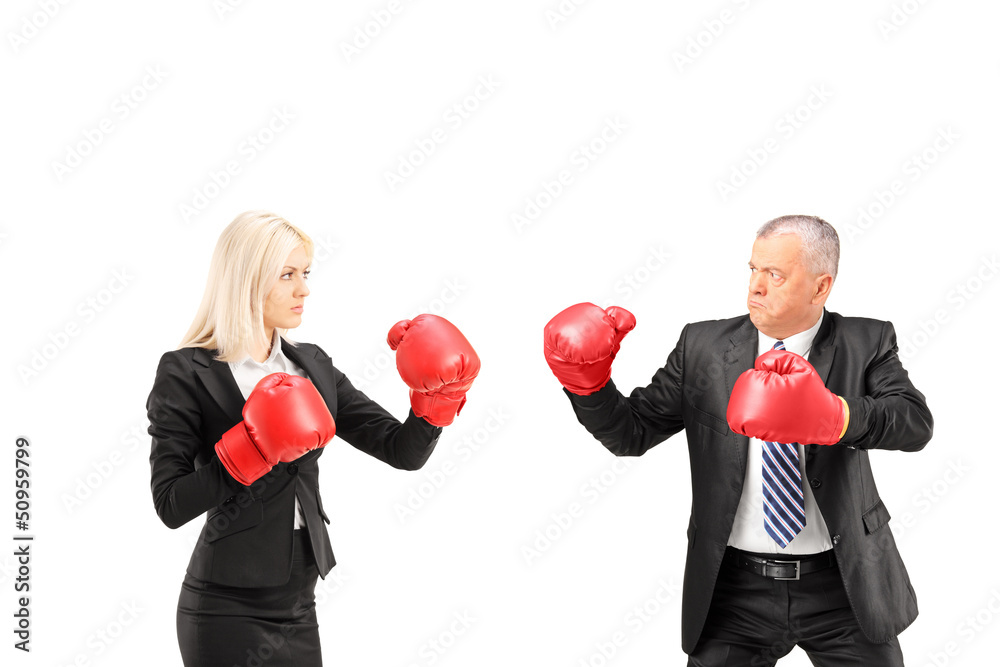Businesswoman and businessman with boxing gloves having a fight Businesswoman and businessman with boxing gloves having a fight