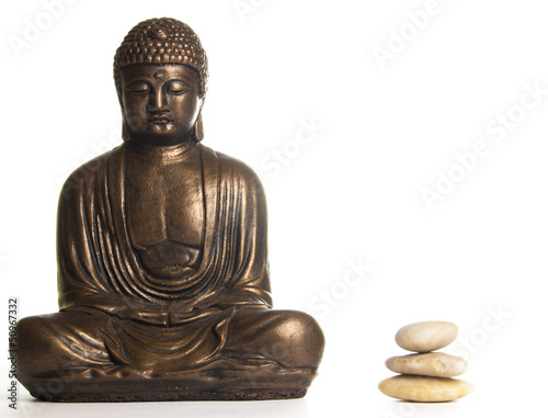 Buddha in Meditation next to a pile of Stones