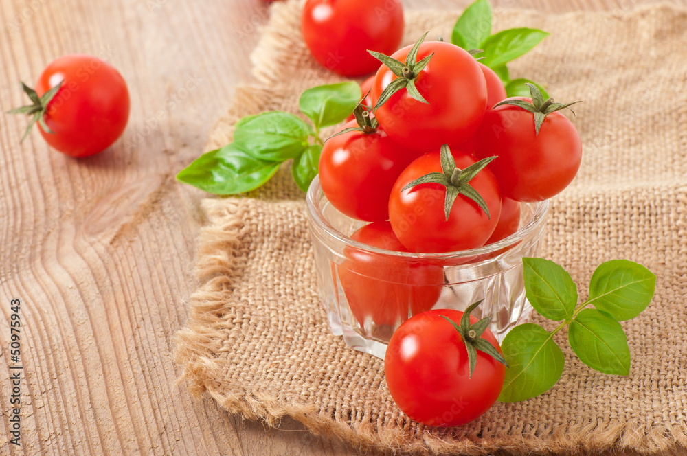 Cherry tomatoes in a bowl with basil Cherry tomatoes in a bowl with basil
