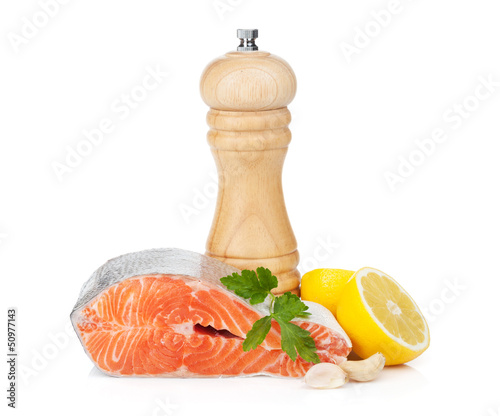 Salmon with herbs, pepper shaker and lemon