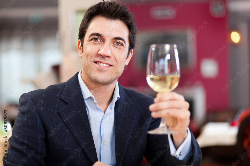 Man toasting wine in a restaurant Man toasting wine in a restaurant