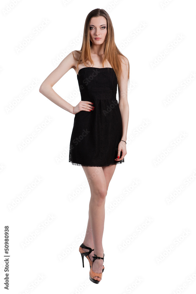 Attractive young woman in a black dress smiling and looking at c Attractive young woman in a black dress smiling and looking at c