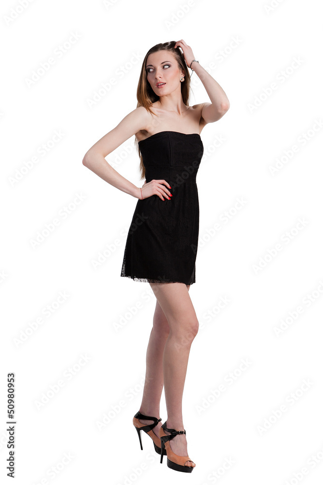 Attractive young woman in a black dress smiling and looking at c Attractive young woman in a black dress smiling and looking at c