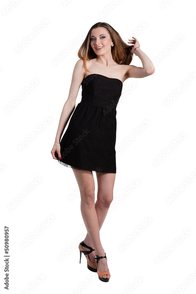Attractive young woman in a black dress smiling and looking at c Attractive young woman in a black dress smiling and looking at c