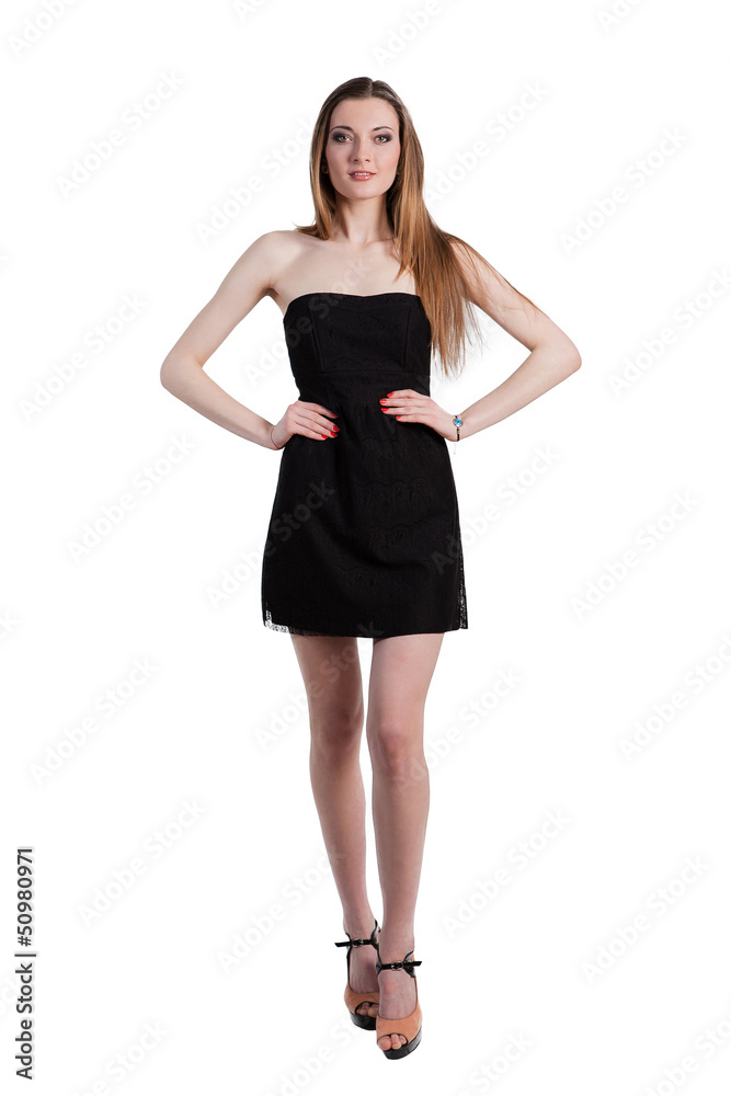 Attractive young woman in a black dress smiling and looking at c Attractive young woman in a black dress smiling and looking at c