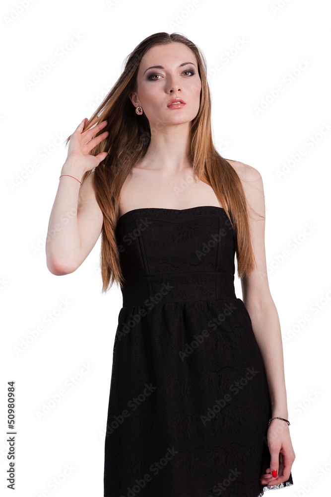 Attractive young woman in a black dress smiling and looking at c Attractive young woman in a black dress smiling and looking at c