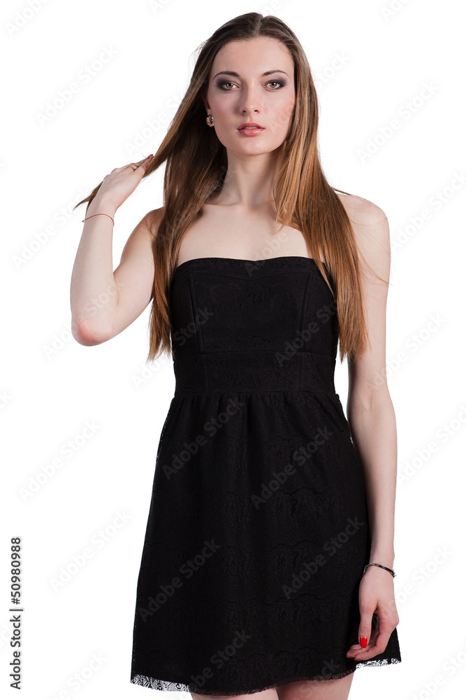 Attractive young woman in a black dress smiling and looking at c Attractive young woman in a black dress smiling and looking at c