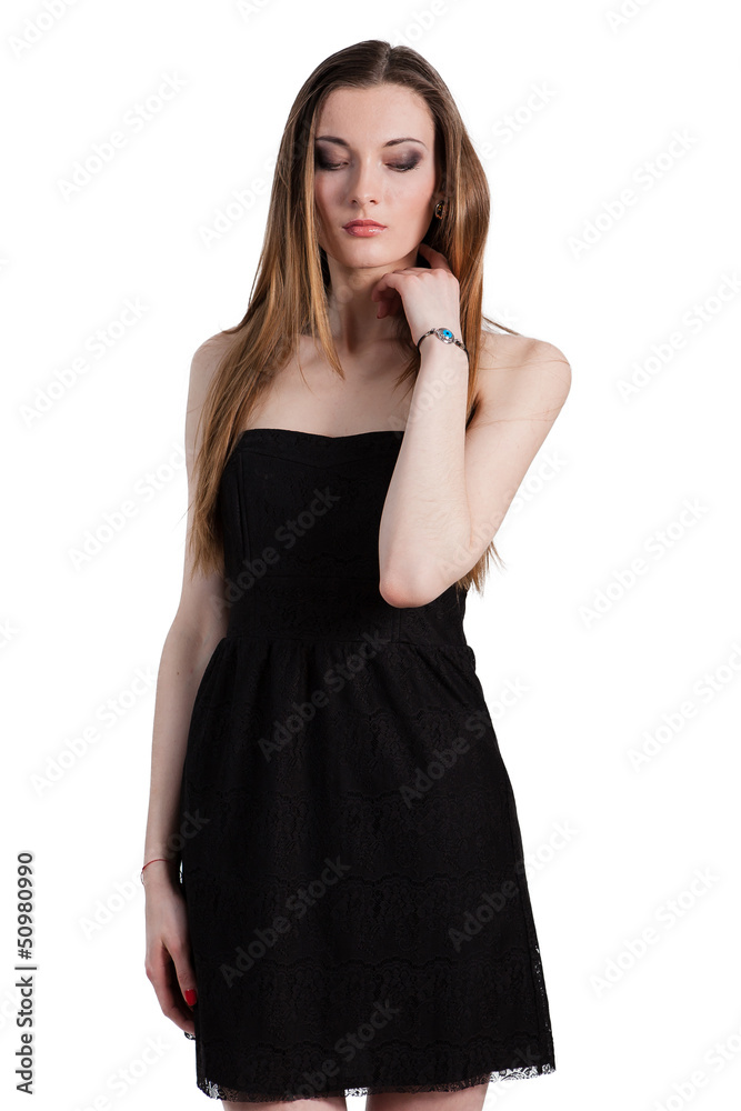 Attractive young woman in a black dress smiling and looking at c Attractive young woman in a black dress smiling and looking at c