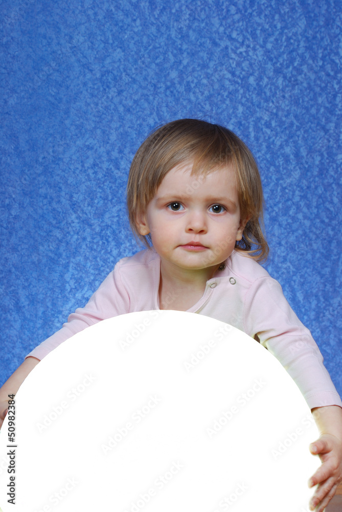 Child with ball, portrait on a blue background