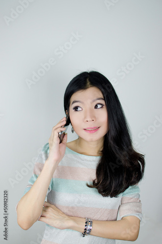 Asian woman using telephone