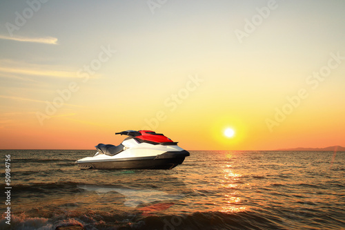 jetski above the water at sunset