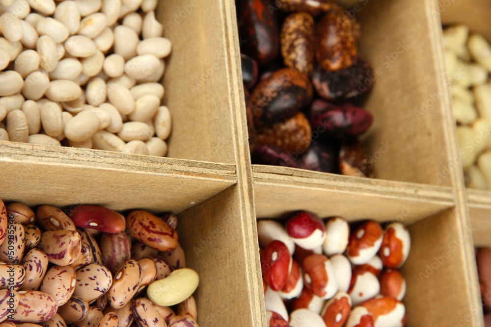 Diverse beans in wooden box sections close-up Diverse beans in wooden box sections close-up