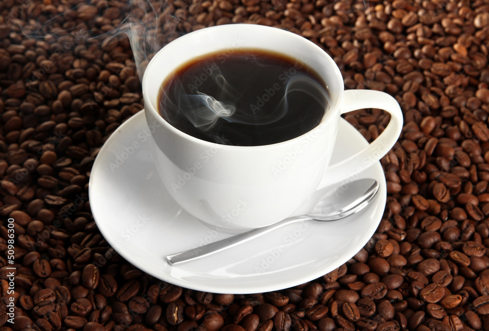 Cup of coffee on coffee beans background Cup of coffee on coffee beans background
