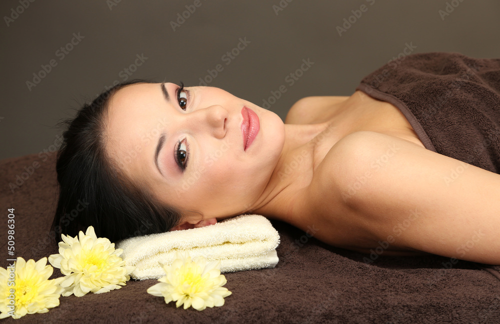 Beautiful young woman in spa salon, on dark background Beautiful young woman in spa salon, on dark background