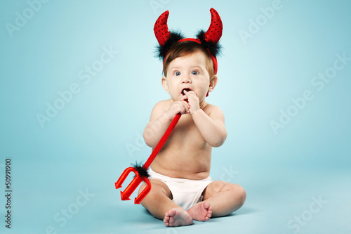 little funny baby with devil horns and trident