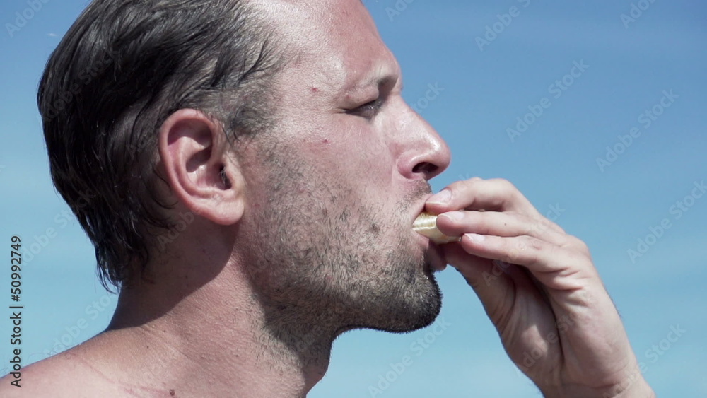 Man eating orange slice, super slow motion, shot at 240fps Man eating orange slice, super slow motion, shot at 240fps