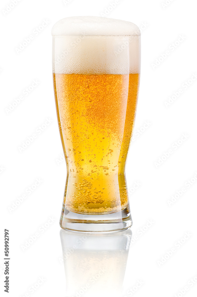 Glass of fresh beer with cap of foam isolated on a white backgro Glass of fresh beer with cap of foam isolated on a white backgro