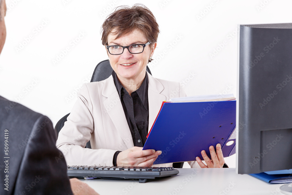 Business woman with folder speaks to man in a suit Business woman with folder speaks to man in a suit