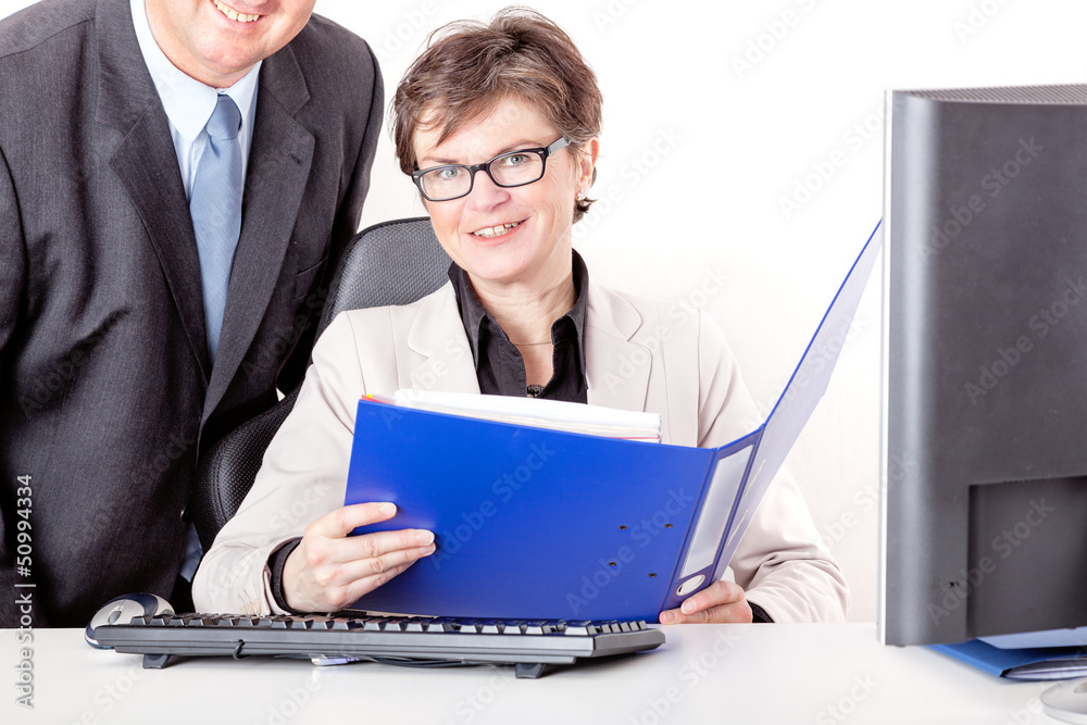 Chief looks together with staff in file folders Chief looks together with staff in file folders