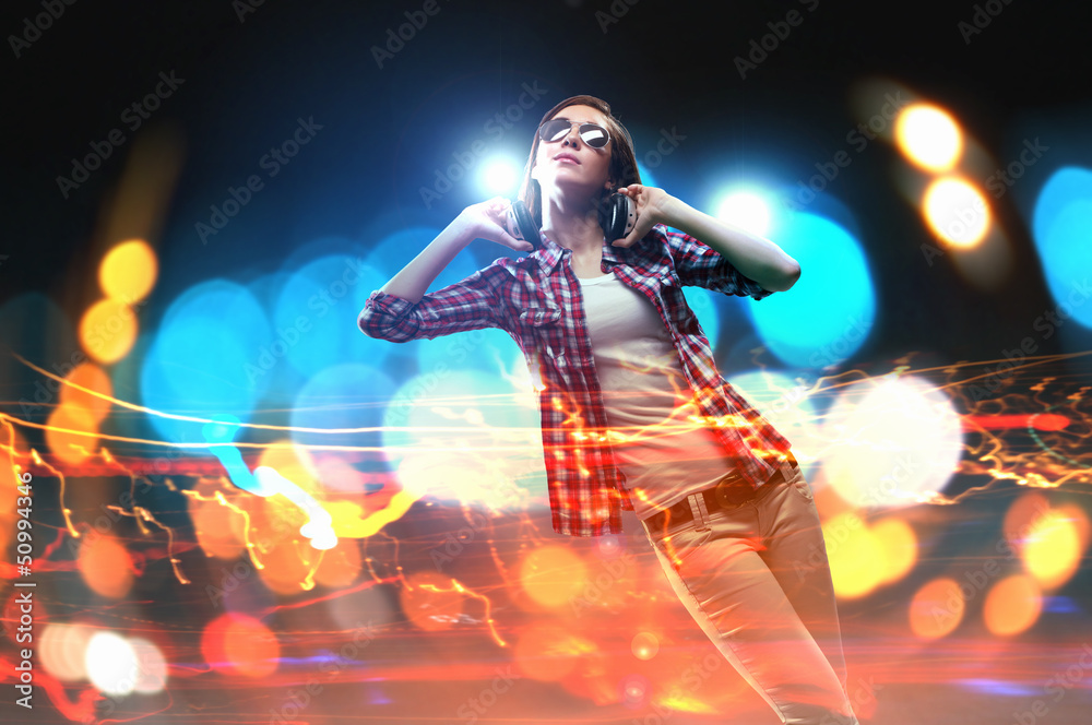 Fototapeta premium Young girl listens to music